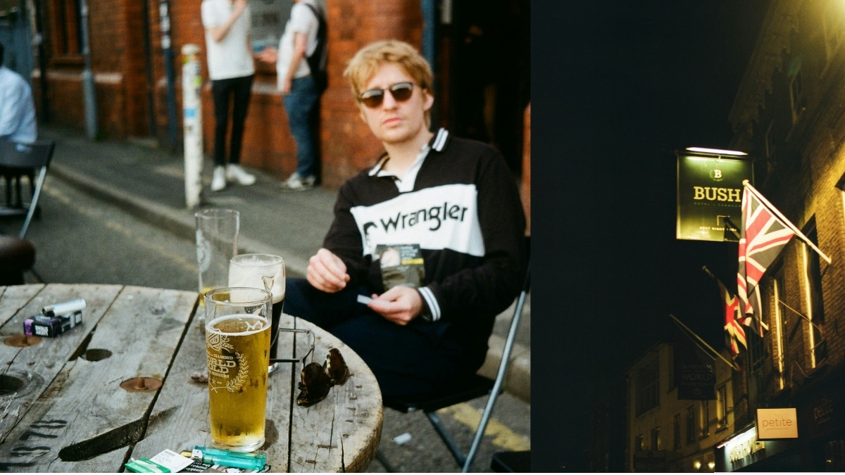 Mann mit Sonnenbrille im Außenbereich eines Pubs, auf dem Holztisch stehen Pint-Bier und weitere Gläser.